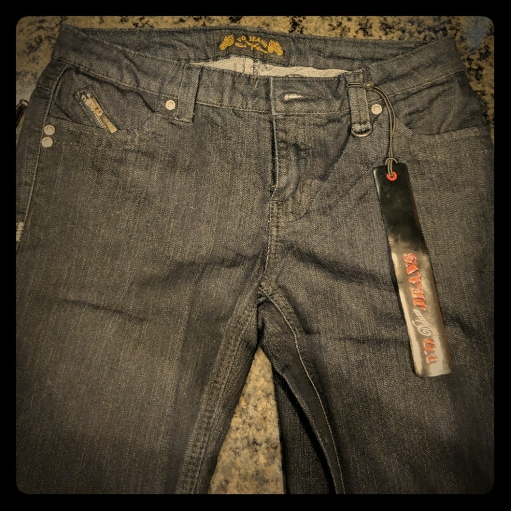 Dark wash jeans with spike and leather details